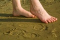Barefoot legs on beach sand Royalty Free Stock Photo