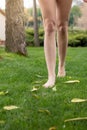 Barefoot feet of a woman walking on the grass to feel the freshness of the earth Royalty Free Stock Photo