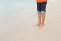 Barefoot legs walking in the seashore, Vacation on summer sea Royalty Free Stock Photo