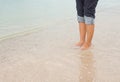 Barefoot legs walking in the seashore, Vacation on summer sea Royalty Free Stock Photo