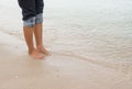 Barefoot legs walking in the seashore, Vacation on summer sea Royalty Free Stock Photo