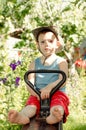 Barefoot little boy playing in the garden Royalty Free Stock Photo