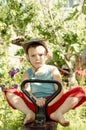 Barefoot little boy playing in the garden Royalty Free Stock Photo