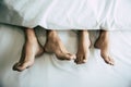 Barefoot of lovers under blanket in bedroom. Vacation and Happiness of sexual. Valentines day theme. Holiday morning theme