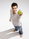 Barefoot man holding fresh green apple