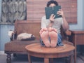 Barefoot man reading at home Royalty Free Stock Photo