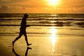 Barefoot man running ocean beach sunset. Royalty Free Stock Photo