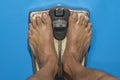 Barefoot man on the scales weighing himself