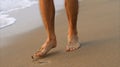 barefoot man walking on the beach at sunset Royalty Free Stock Photo