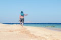 Barefoot man walks along the sandy sea coast Royalty Free Stock Photo