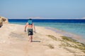 Barefoot man walks along the sandy sea coast Royalty Free Stock Photo