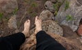 Barefoot and muddy man resting on a rock in the mountain Royalty Free Stock Photo