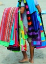 barefoot pedlar of cloth and towels on the beach