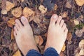 Barefoot person standing on the ground in autumn forest Royalty Free Stock Photo