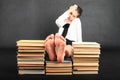 Soles of bare feet of teenage girl on top of old books Royalty Free Stock Photo