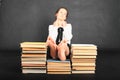 Soles of bare feet of teenage girl on top of old books Royalty Free Stock Photo