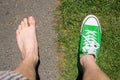 Barefoot versus wearing sneakers grass versus asphalt Royalty Free Stock Photo