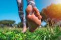 Barefoot walking. Closeup of woman running barefoot in the park on green grass Royalty Free Stock Photo