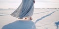 Barefoot woman in a long dress stands in a snowdrift on a frosty winter day , concept of Winter solitude, created with