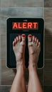 Barefoot of woman standing on the weight scale. The scale shows ALERT! Royalty Free Stock Photo