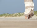 Barefoot woman walking away at the beach Royalty Free Stock Photo