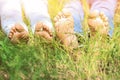 Barefoot young couple lying on green grass in park Royalty Free Stock Photo