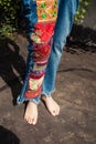 Barefoot young woman in boho style embroidered blue jeans lower Royalty Free Stock Photo