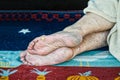 Barefooted homeless or refugee person sleeping on the street with dry and dirty feet skin