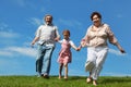 Barefooted little girl and grandparents running