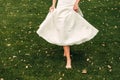 Young fair-haired bride walking along the grass in an exotic park Royalty Free Stock Photo