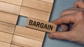 BARGAIN word concept. Close-up wooden piece blocks on the table