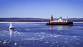 barge being pushed North up frozen Hudson River