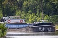 Barge or Boat on the old canal between the trees and fields in Rijkevorsel, Belgium Royalty Free Stock Photo