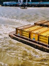 Barge with containers being dragged on the Thames London