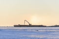 Barge with crane. Dredger working at sea. Sunset in Arctic sea. Construction Marine offshore works. Dam building, crane, barge,