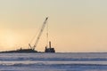 Barge with crane. Dredger working at sea. Sunset in Arctic sea. Construction Marine offshore works. Dam building, crane, barge,