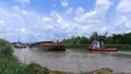 The barge docks at the jetty to load palm oil