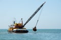 Barge dredging a harbor Royalty Free Stock Photo