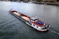 Barge filled with a cargo of sand navigating on the Seine river Royalty Free Stock Photo