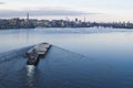 The barge floating in the Dnieper river. Kyiv city landscape in the background. 17.11.2018