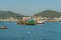 Barge with industrial crane on water in small seaport Royalty Free Stock Photo