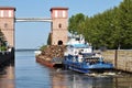 A barge loaded with garbage passes through the locks