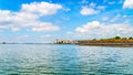 Barge loaded with Logs traveling on the Veluwemeer under Blue Sky with a Few Clouds