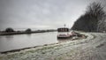 A barge moored in winter at the shore