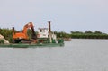 barge on the river with a large digger for construction work