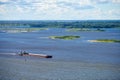 Barge on river sailing to port for cargo. Transport for transportation of crushed stone and sand Royalty Free Stock Photo