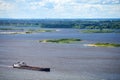 Barge on river sailing to port for cargo. Transport for transportation of crushed stone and sand Royalty Free Stock Photo