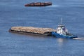 The barge transports cargo, timber logs along the river in summer. Royalty Free Stock Photo