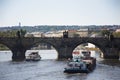 Barge and Tugboat cargo ship and River Cruises sailing in Vltava river near Charles Bridge Royalty Free Stock Photo