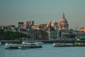 Barges and Tour Boats on the River Thames at Sunset